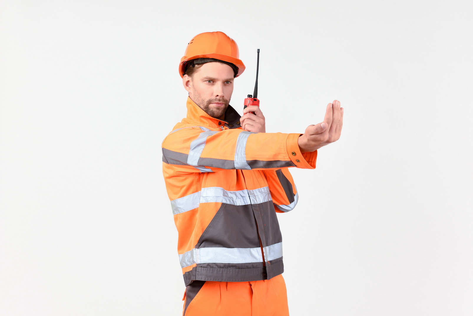 Street worker using radio phone and showing to move closer