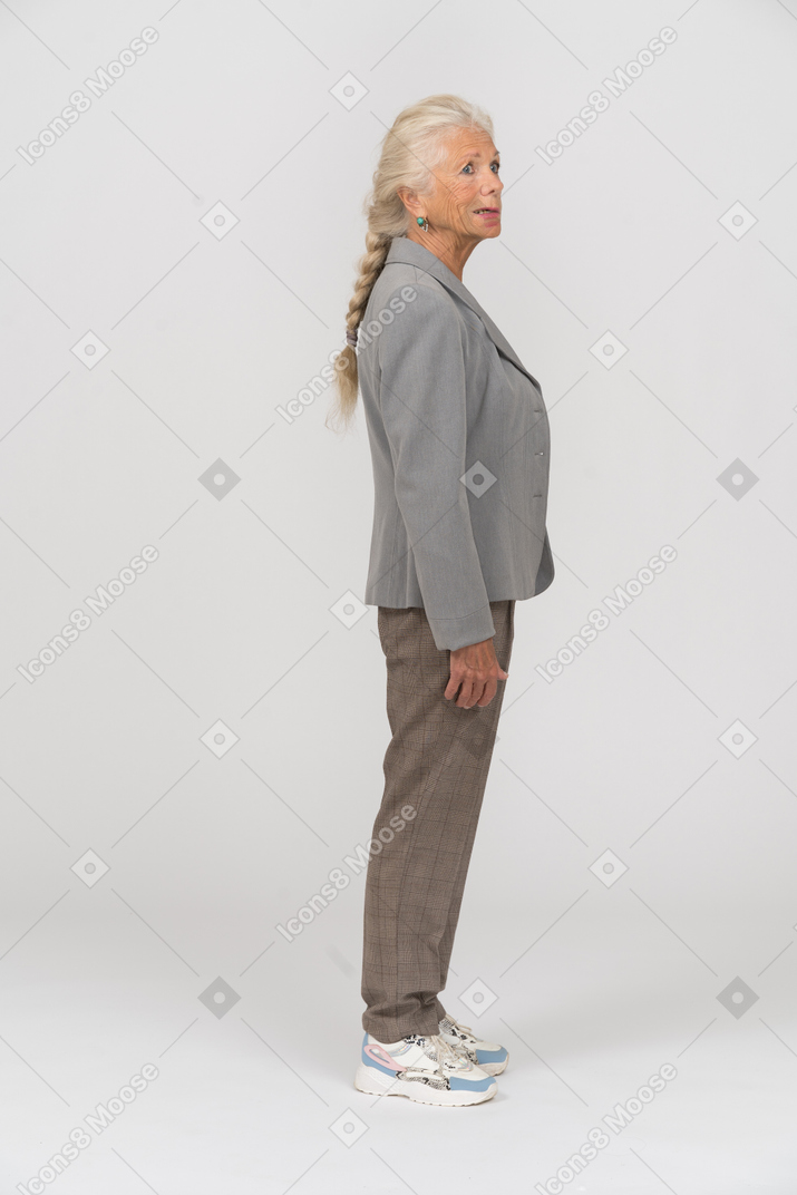 Side view of an old lady in suit thinking about something