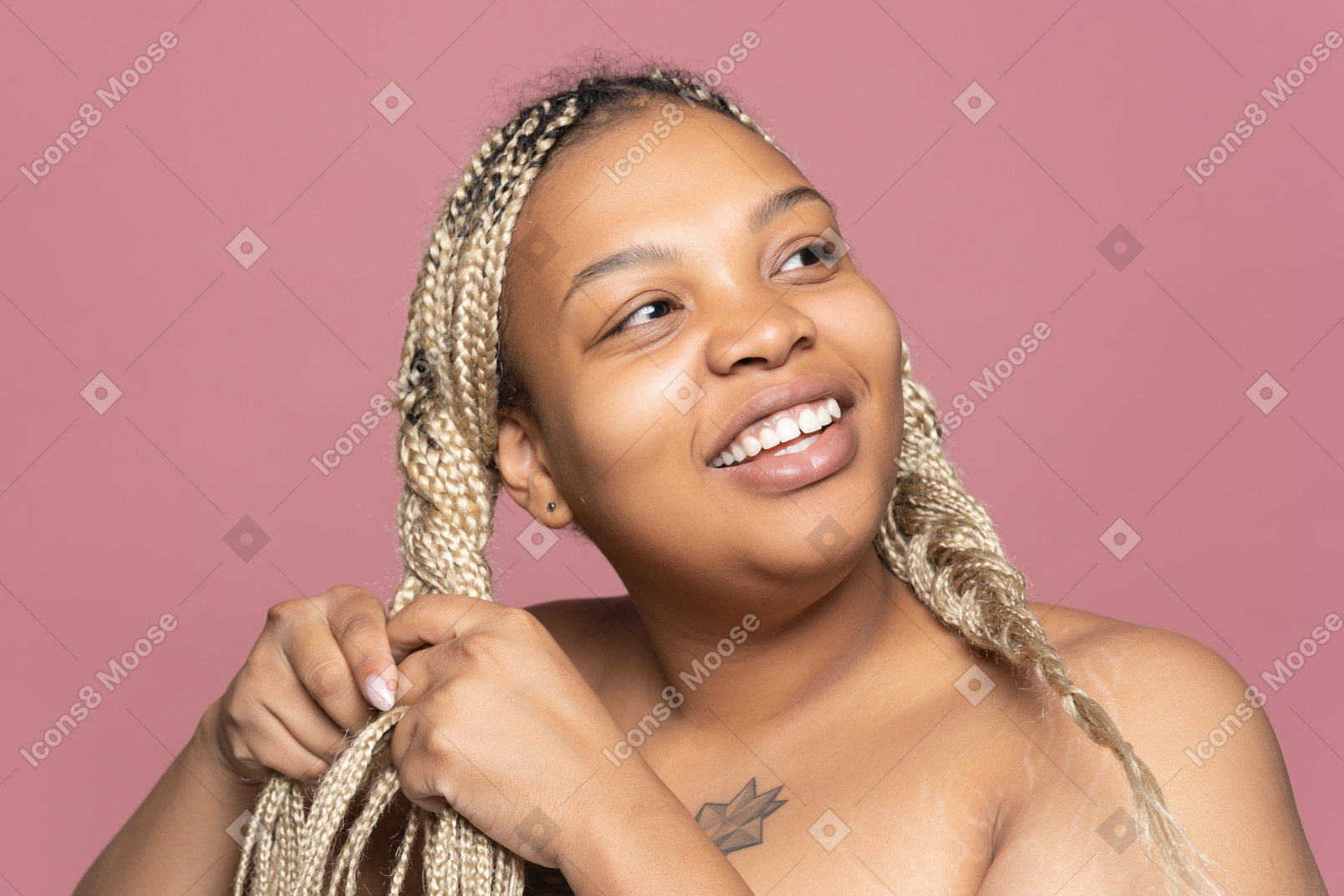 Cheerful african-american woman braiding hair