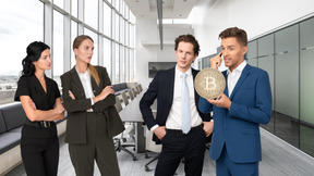 A group of business people holding a bitcoin in an office