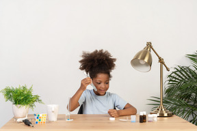 Good looking cute girl doing science at the table