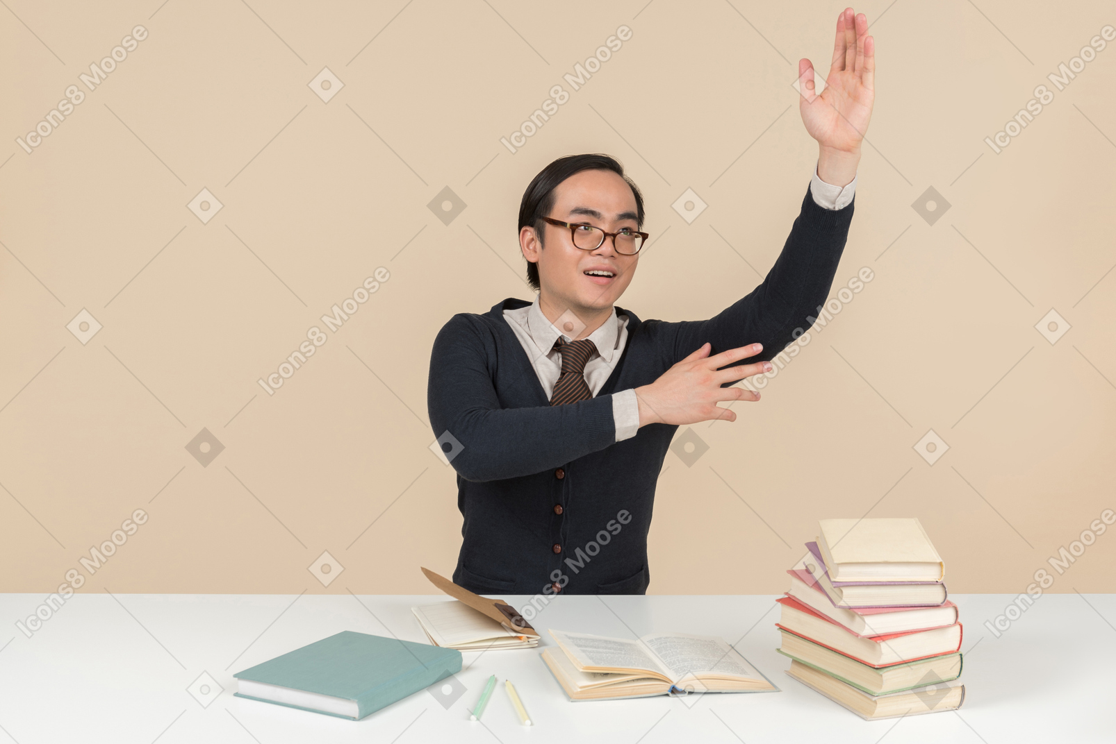 Young asian student in a sweater raising his hand
