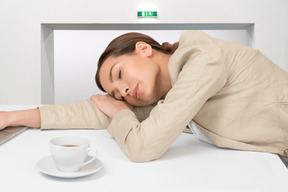 A woman sleeping with her head on desk