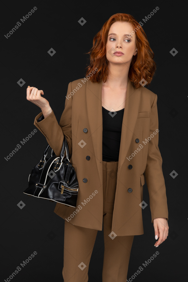 Confident young woman in a brown suit
