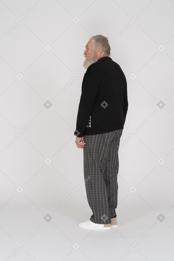 Three-quarter back view an elderly man standing