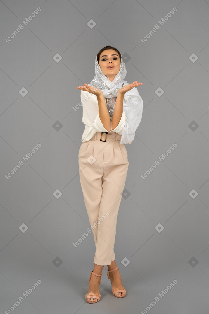 Cute covered middle eastern woman sending kisses
