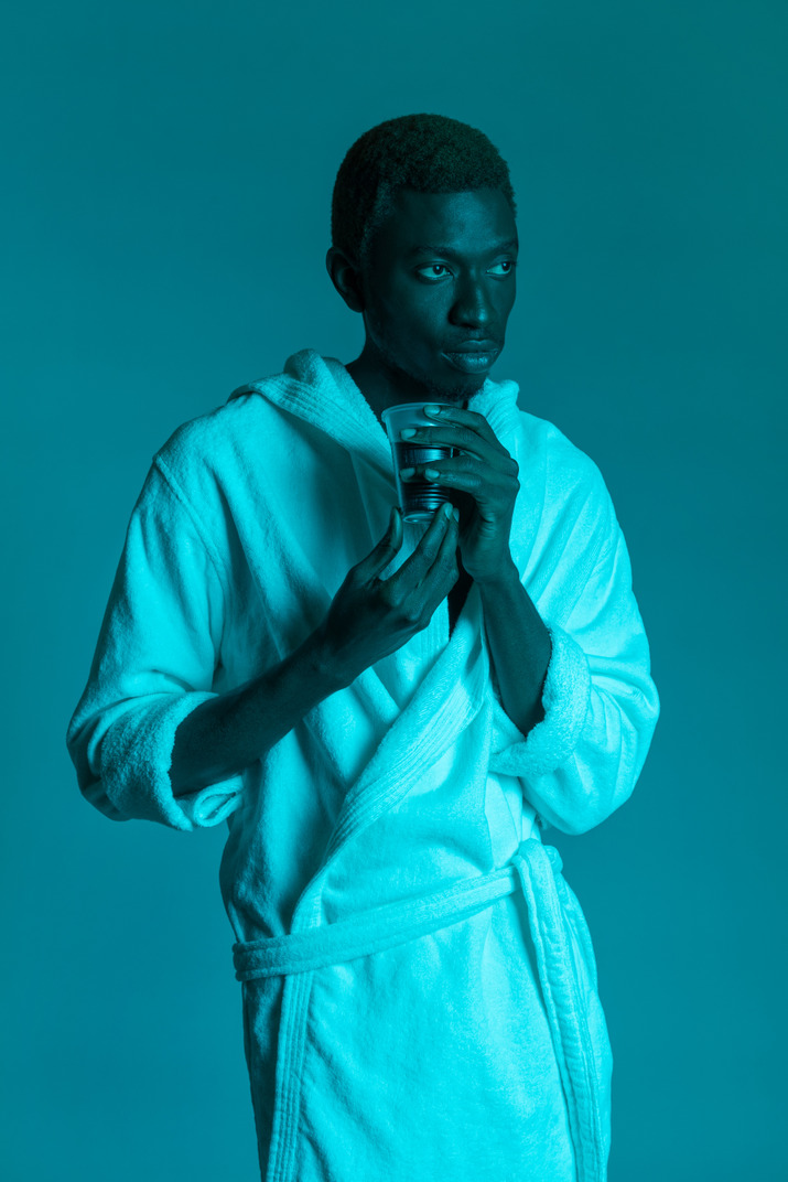 Young black man in white bathrobe
