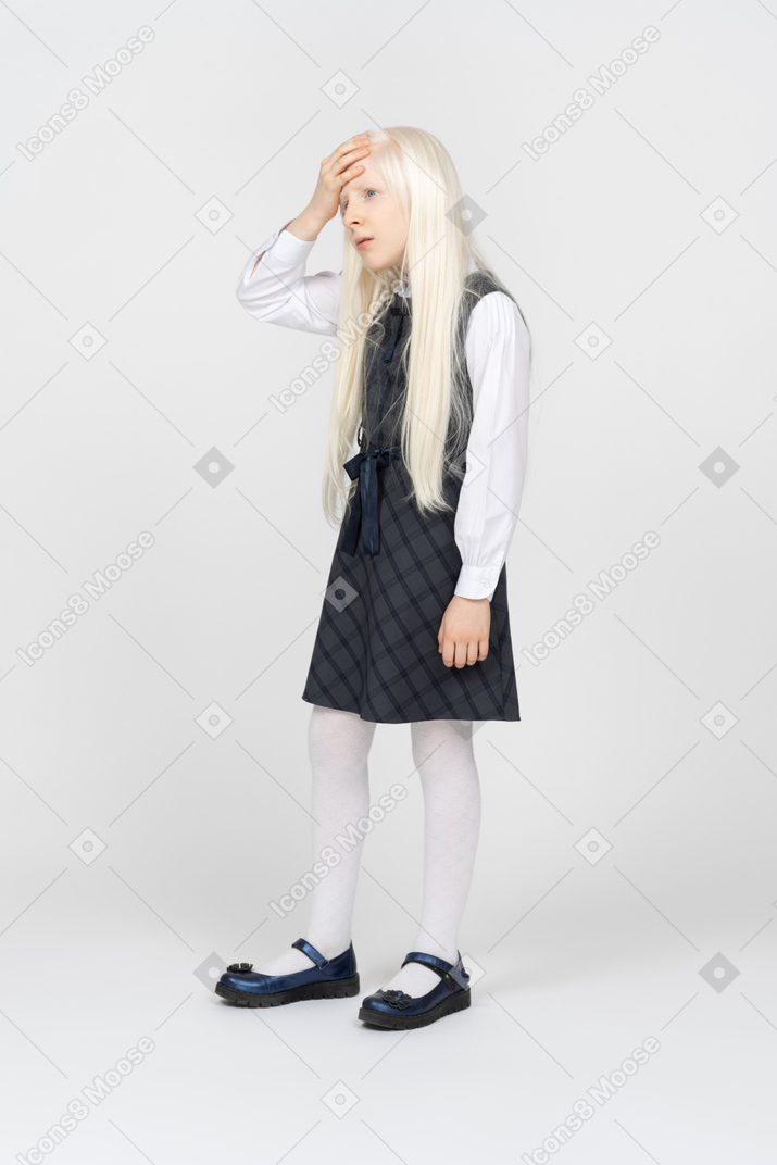 Schoolgirl looking annoyed with hand on forehead