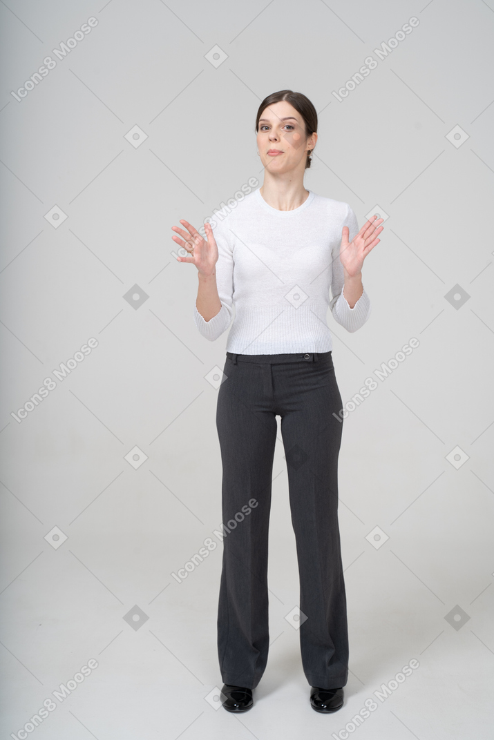 Vue de face d'une jeune femme en costume faisant des gestes