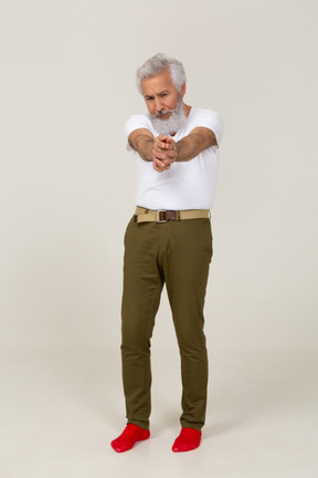 Man in casual clothes aiming a finger gun