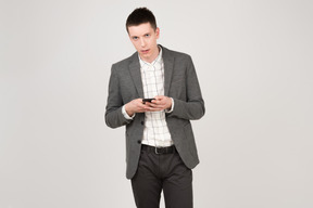 Concerned young man with a smartphone in his hands