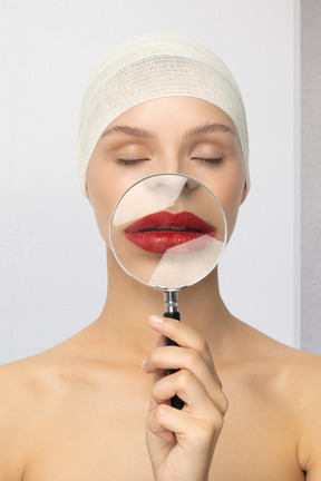 A woman with a magnifying glass over her lips