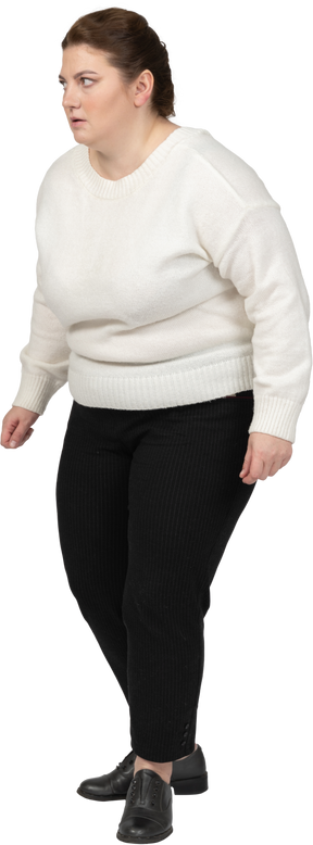 Scared plump woman in casual clothes standing