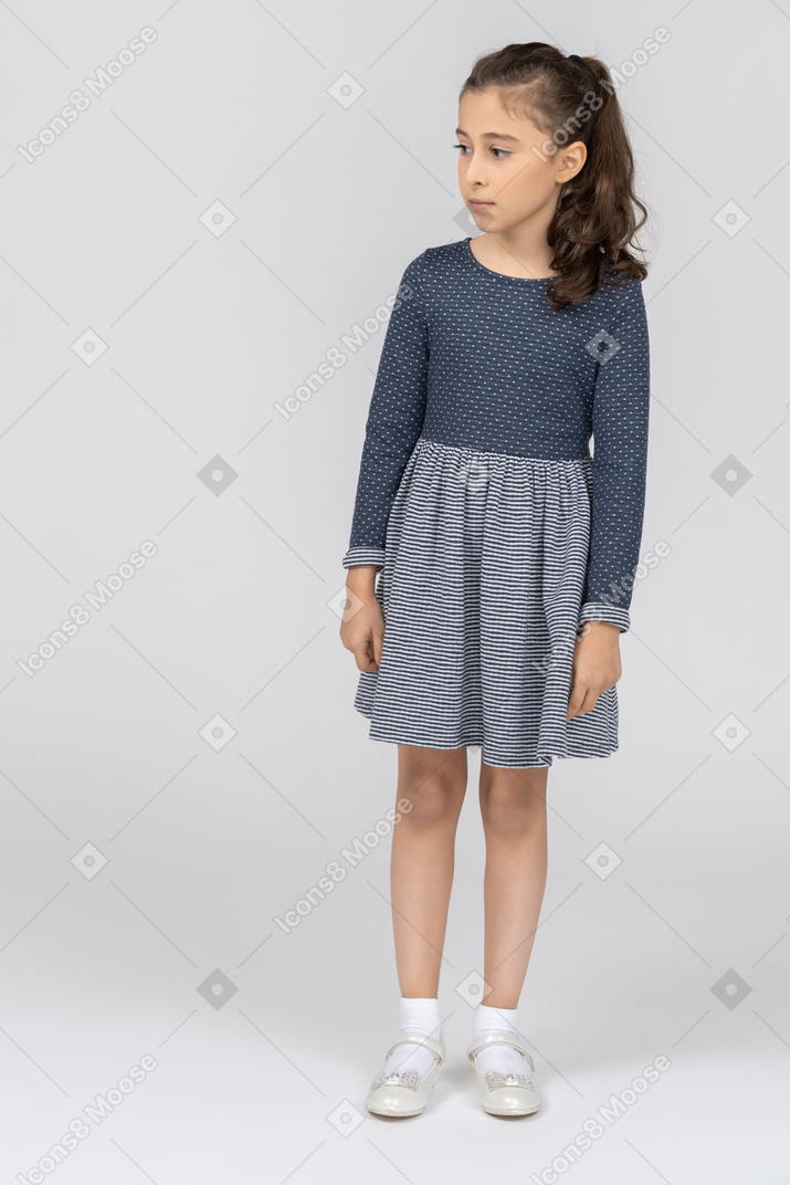 Front view of a girl standing still and looking to the side