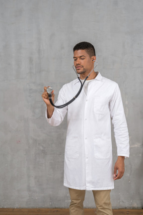 Male doctor using a stethoscope