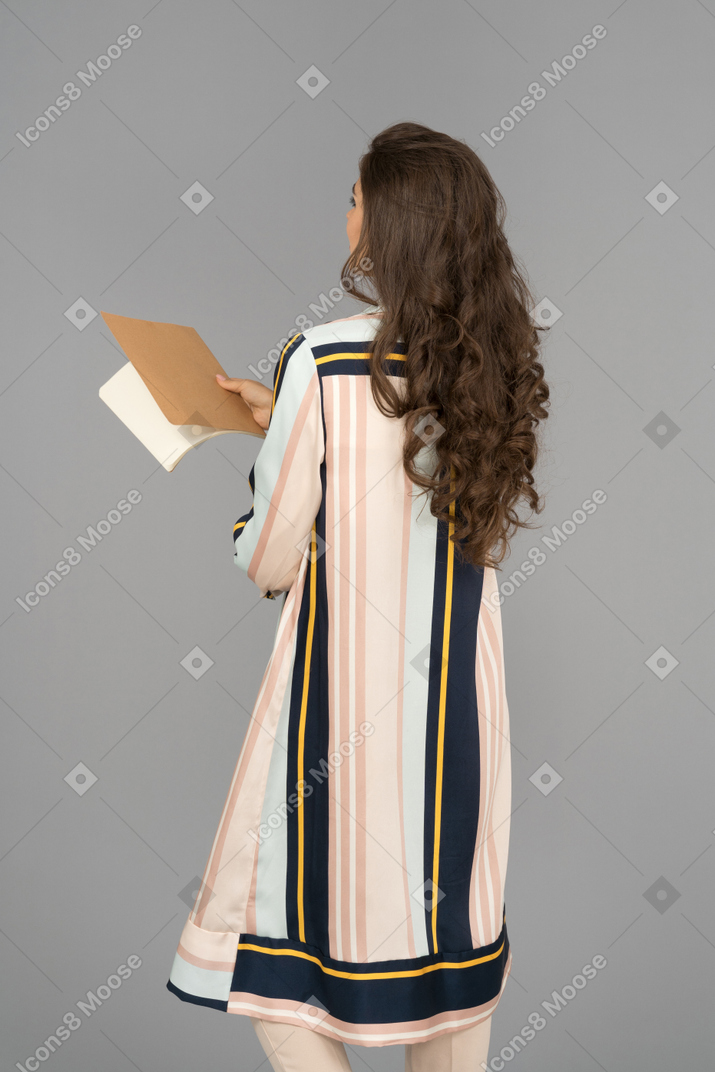 Cheerful arab woman holding a notebook