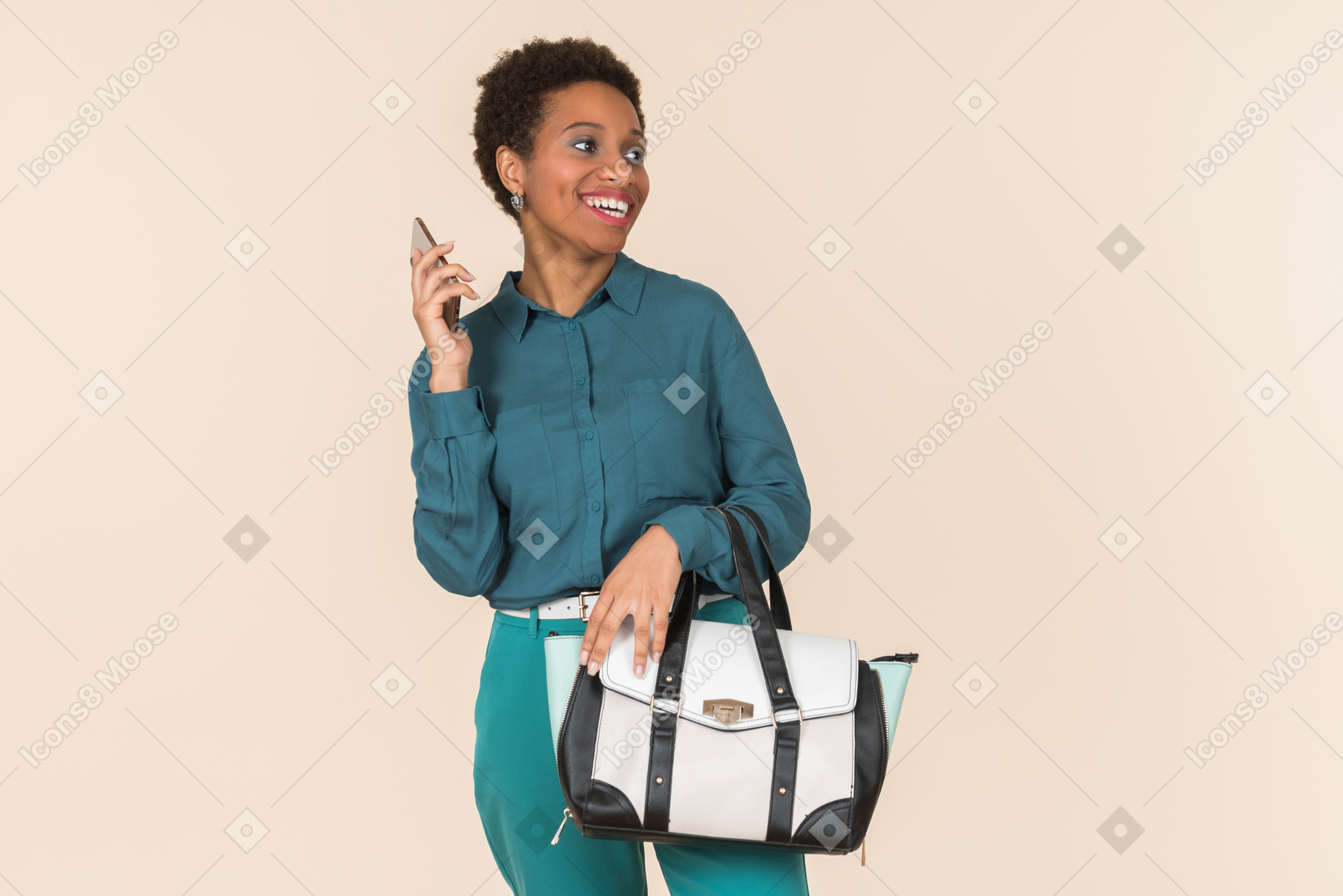 Smiling young woman holding bag and phone