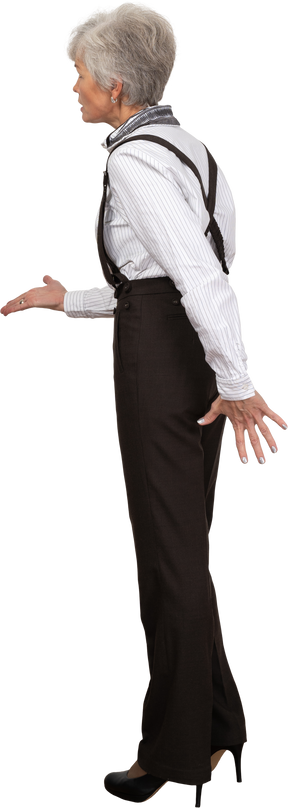 Side view of an old lady in office clothing outstretching her hand
