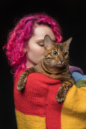 A bengal cat on the shoulder of its owner