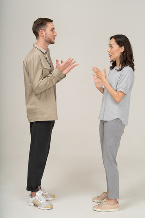 Side view of young couple speaking to each other