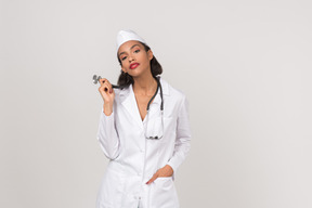 Attractive young female doctor holding a stethoscope