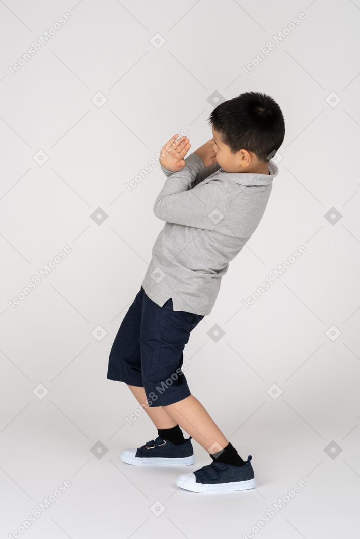 Boy crossing arms