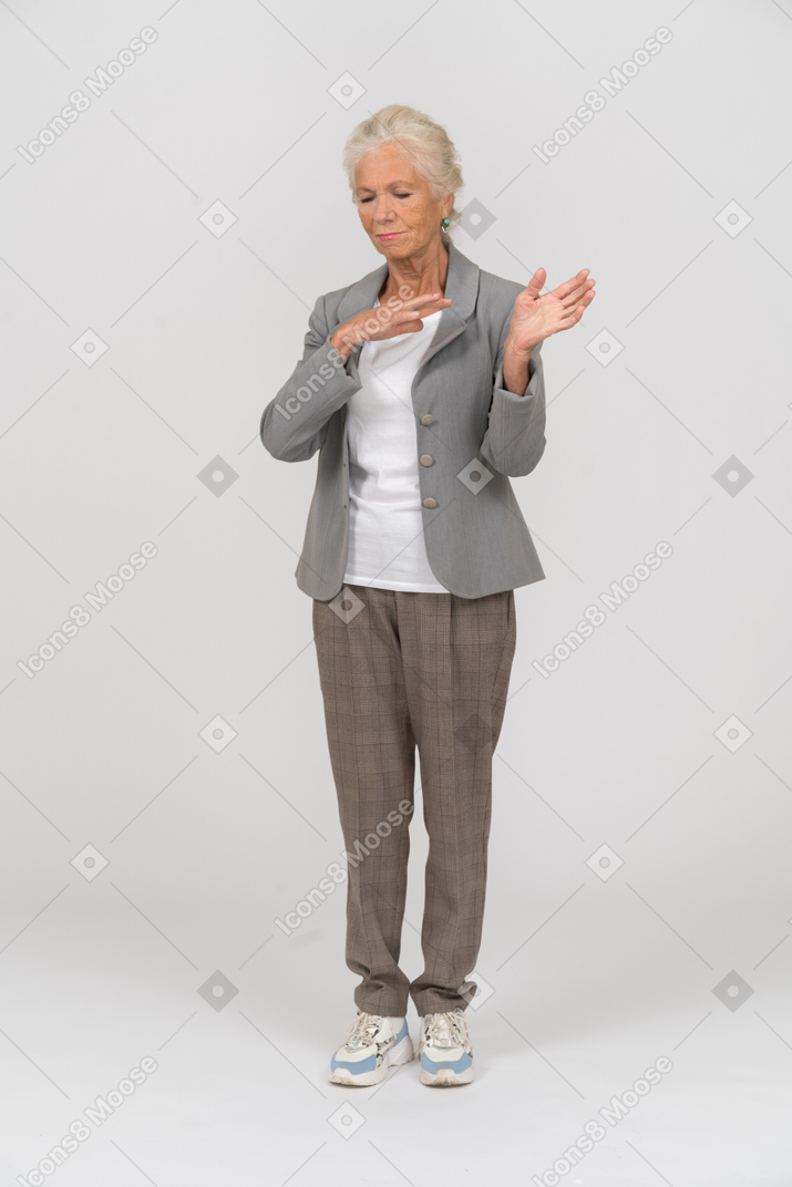 Front view of an old woman in casual clothes gesturing