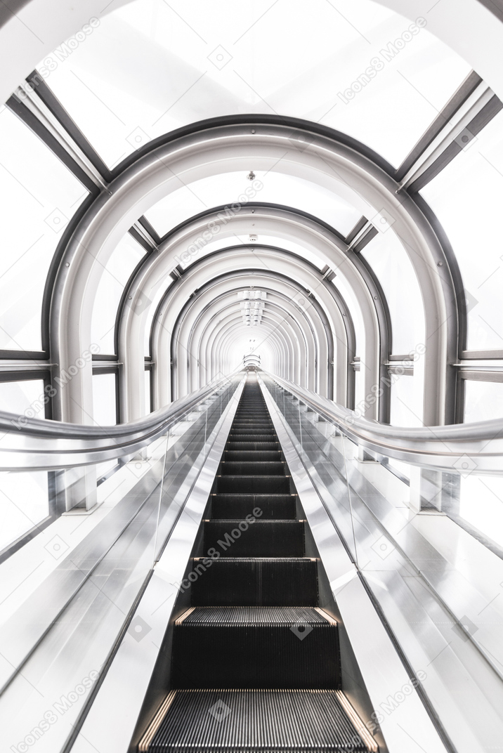 A bright white and black picture of a moving escalator