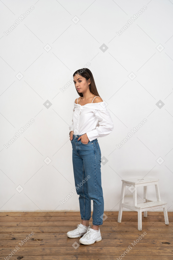 Woman standing with hands in pockets