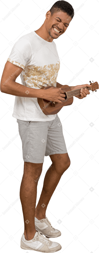Side view of a man playing ukulele and smiling