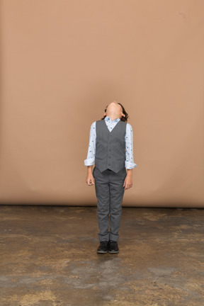 Front view of a boy in suit looking up