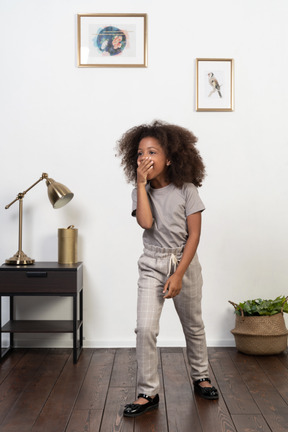 Good looking girl kid posing on the apartment background