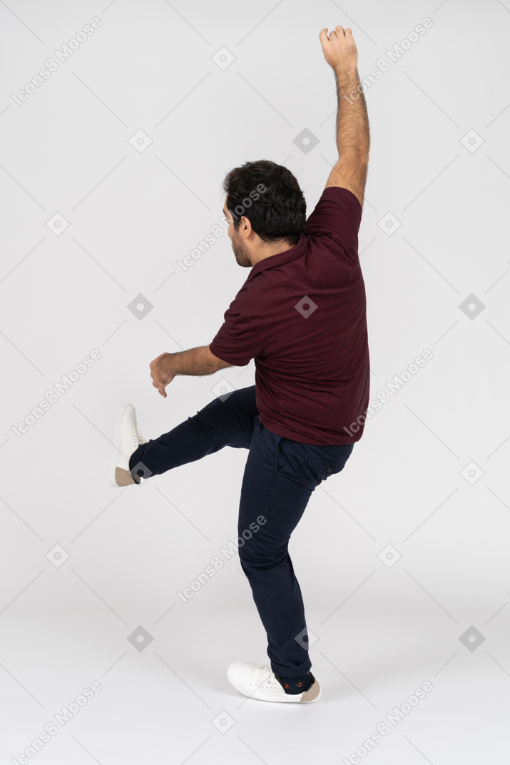 Back view of a man kicking his foot