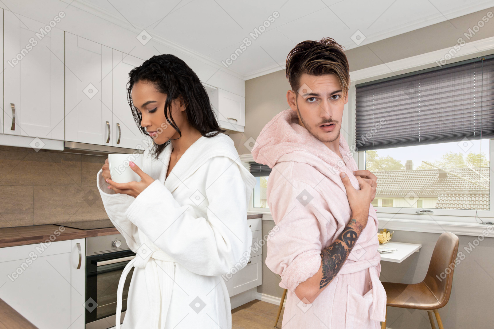 Couple in bathrobes on kitchen background