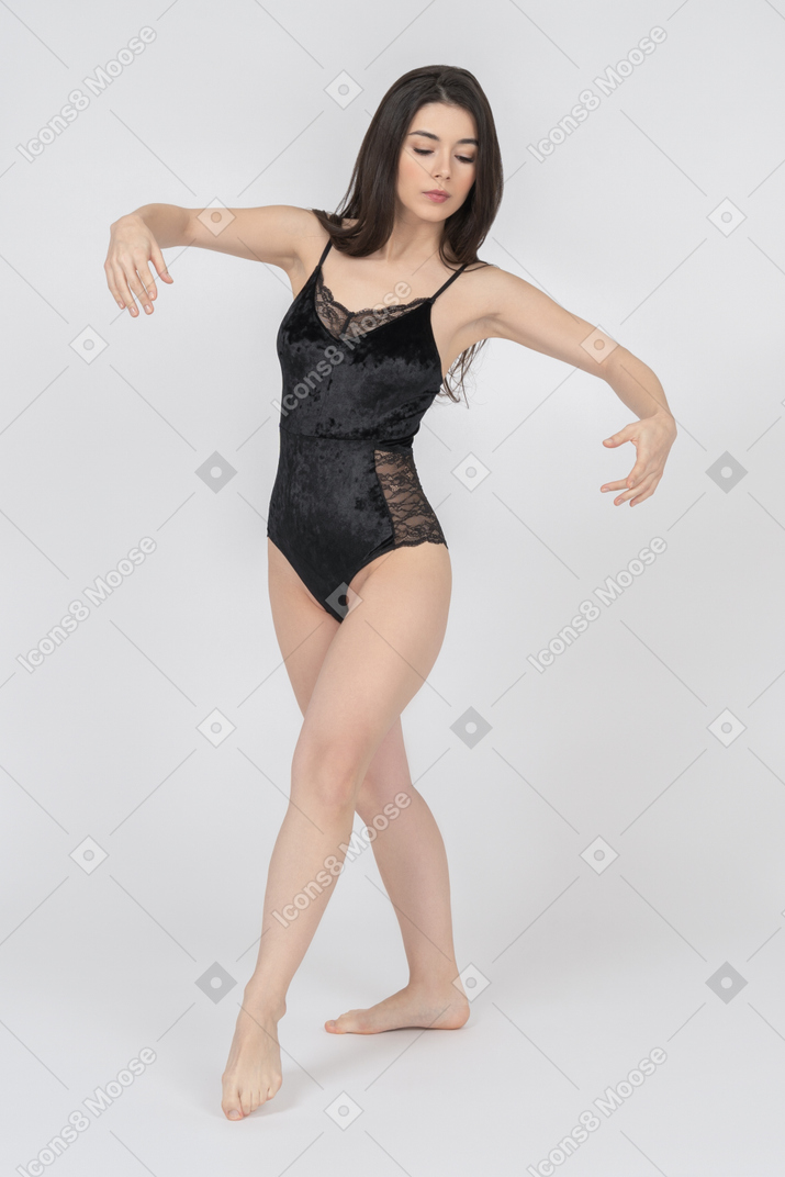 Female in black bodysuit posing in dancing position