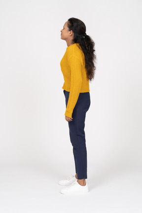 Side view of a girl in casual clothes looking up