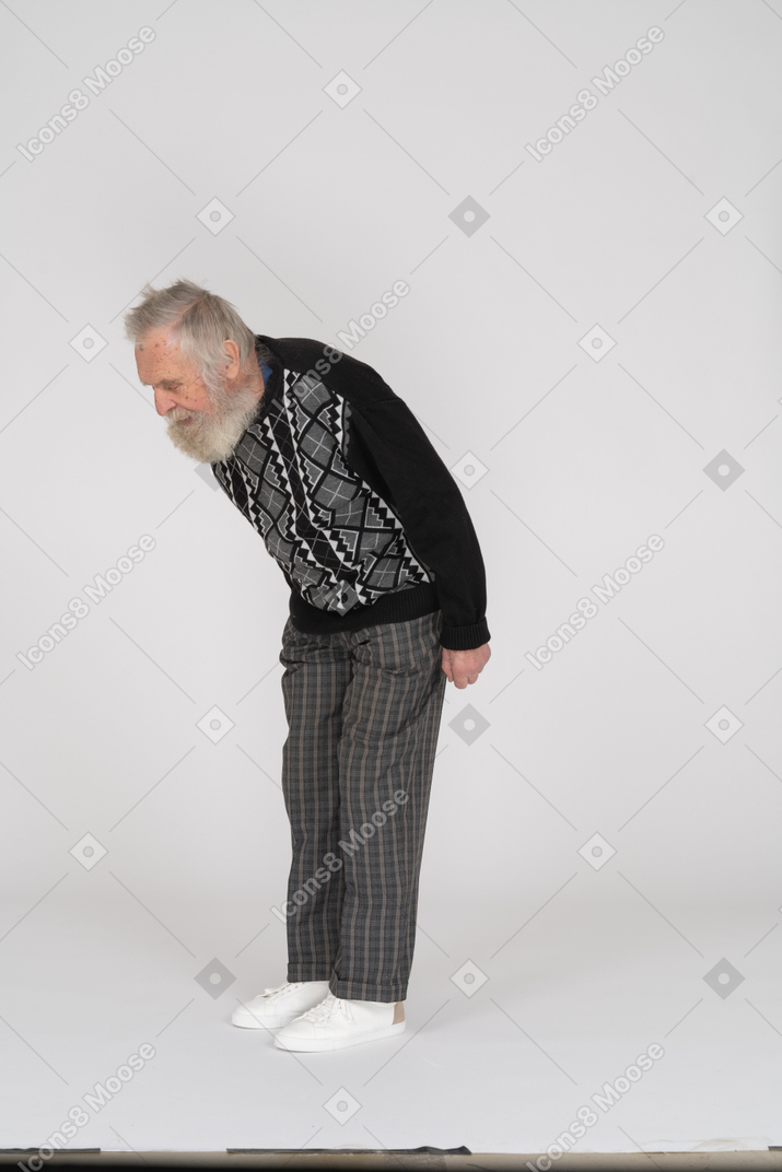 Elderly gentleman bending down