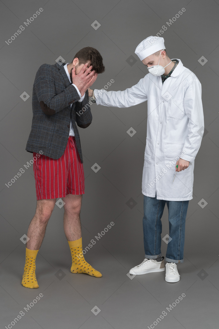Doctor and young man mourning someone
