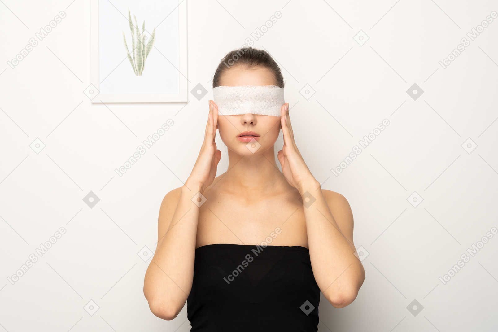 Woman with eye bandage touching sides of face