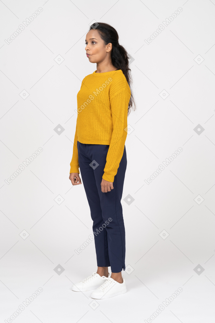 Side view of a beautiful girl in casual clothes making faces