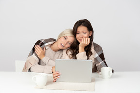 Young women embracing and watching films