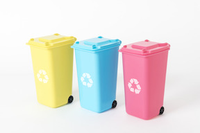 Three colorful trash cans