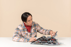 An asian geek guy in a checkered shirt