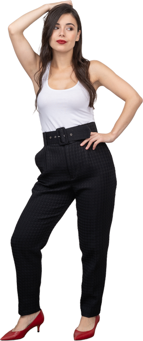 Front view of a confident young woman in office clothing posing and looking aside