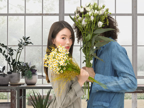A woman and a man holding flowers