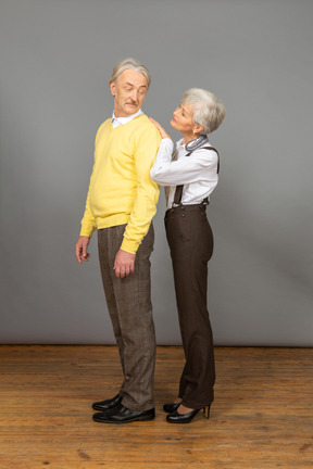 Man looking over his shoulder at his wife