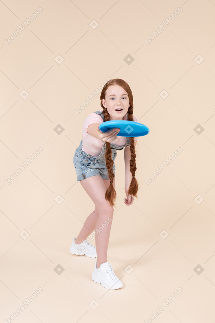Teenage girl passing frisbee