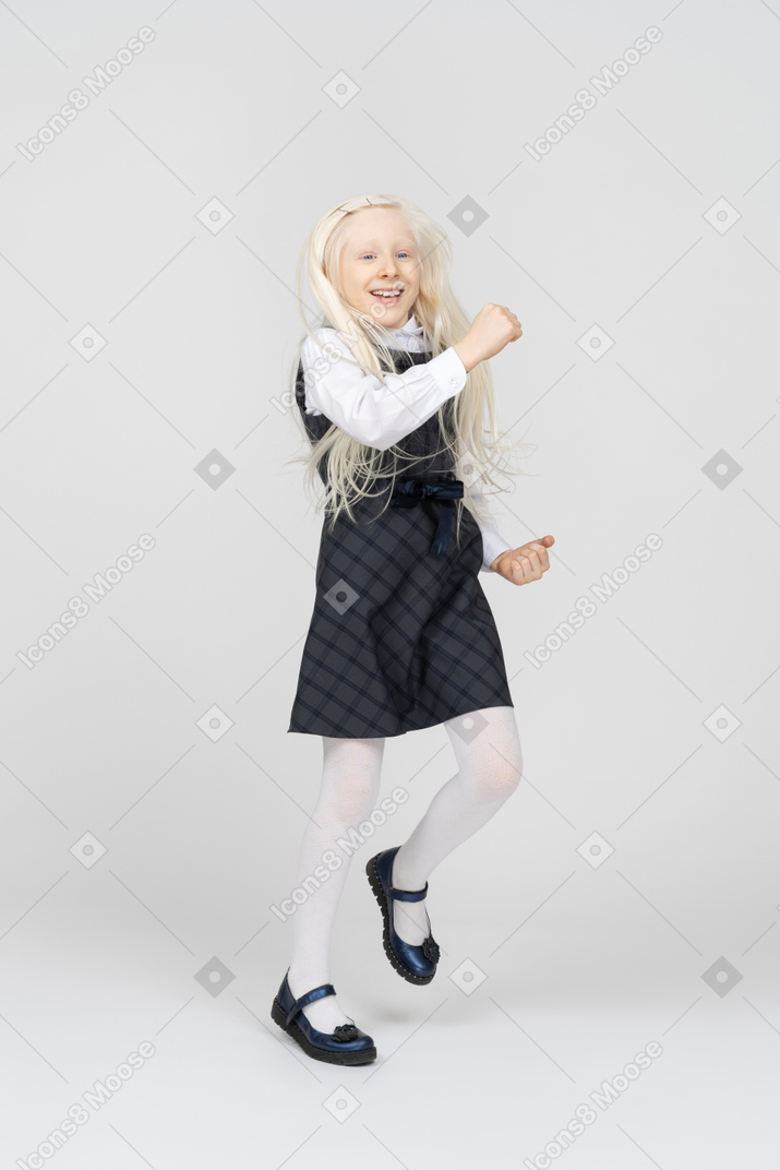 Excited schoolgirl skipping around