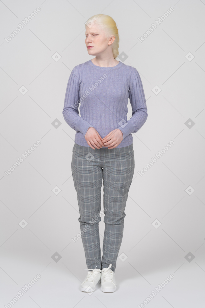 Blonde woman in casual clothes looking aside