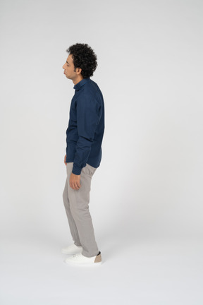 Man in casual clothes standing in profile